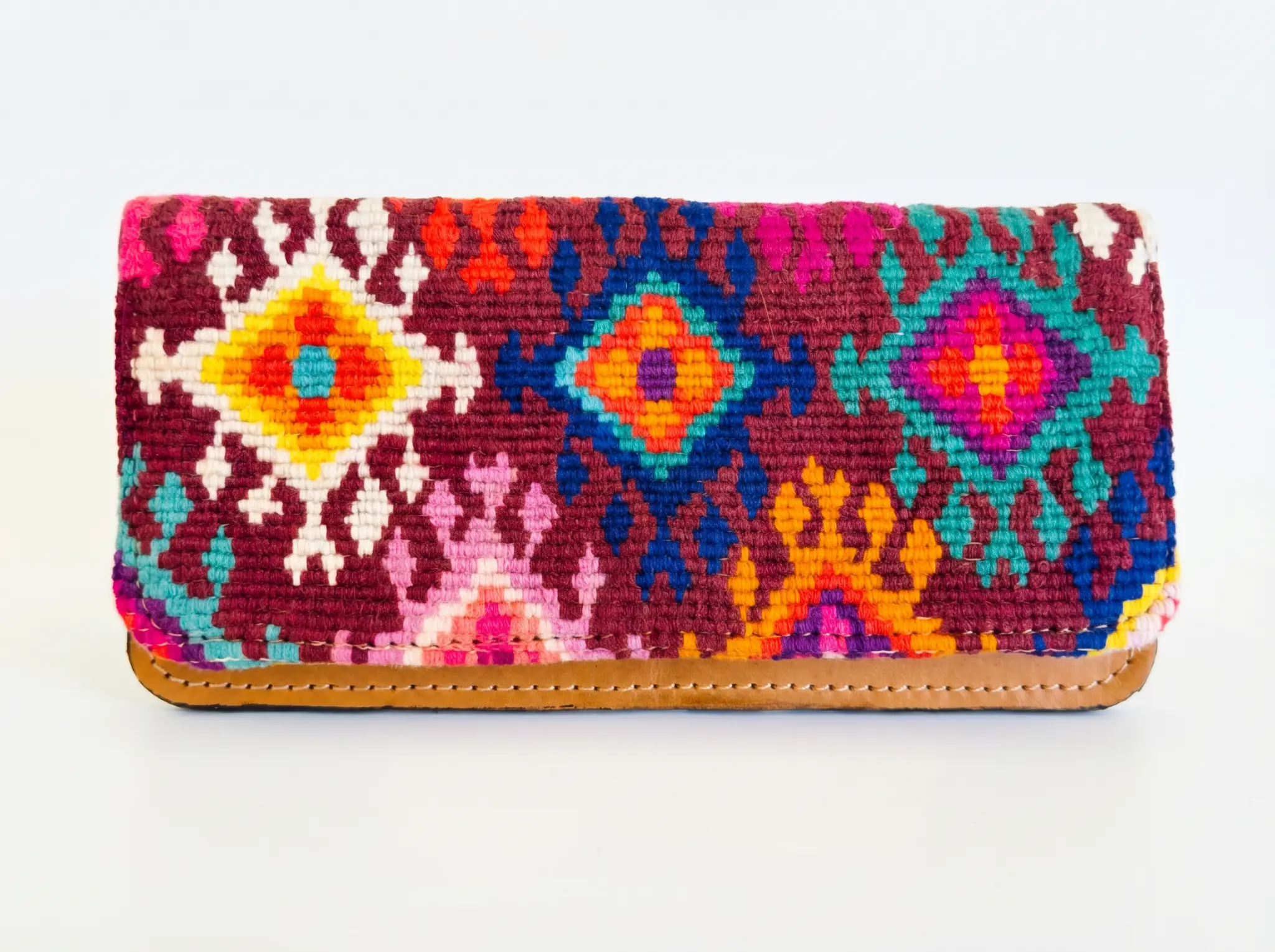 TQC wallet featuring four-direction cosmological motifs in burgundy, teal, and gold