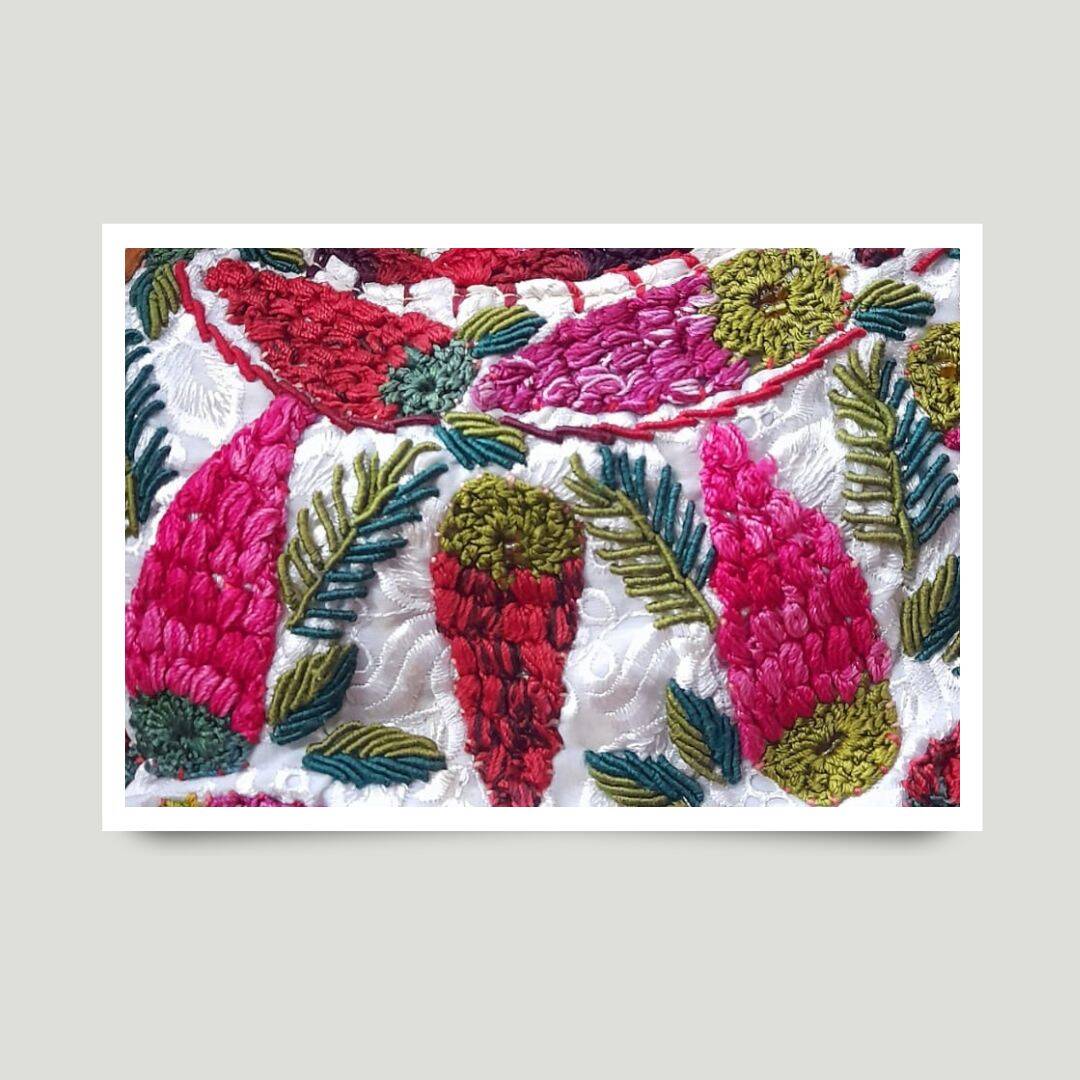 Sacapulas textile with bold red and black stripe bands and diamond-shaped border patterns